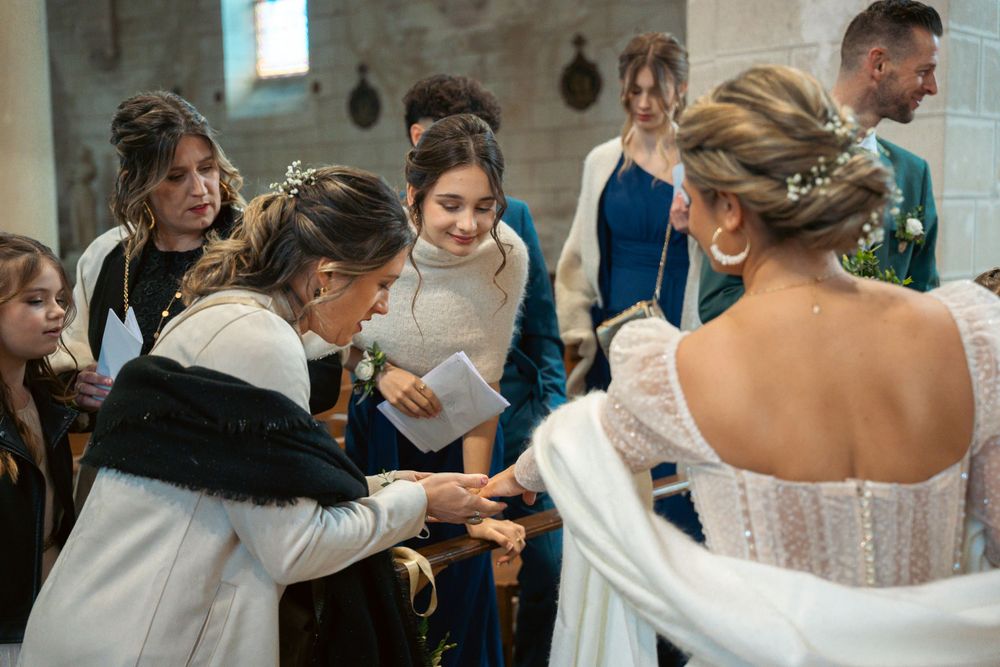 Wedding party gathered in close circle sharing a special moment.