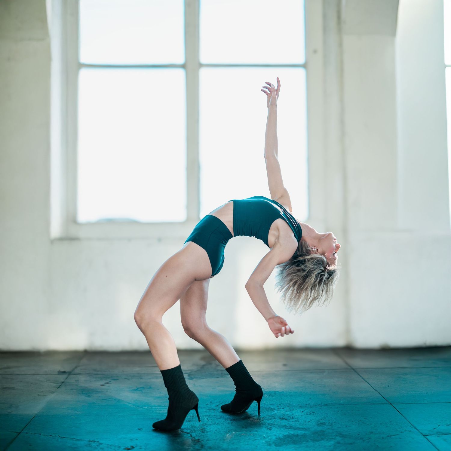 Series of dance movements captured in bright white room with windows.