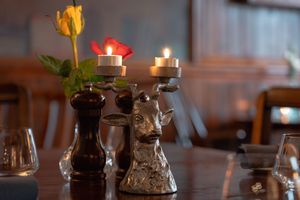 Candlelit table settings create intimate ambiance in a restaurant.