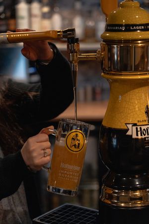 Beer taps and draft system equipment behind a dimly lit bar counter.