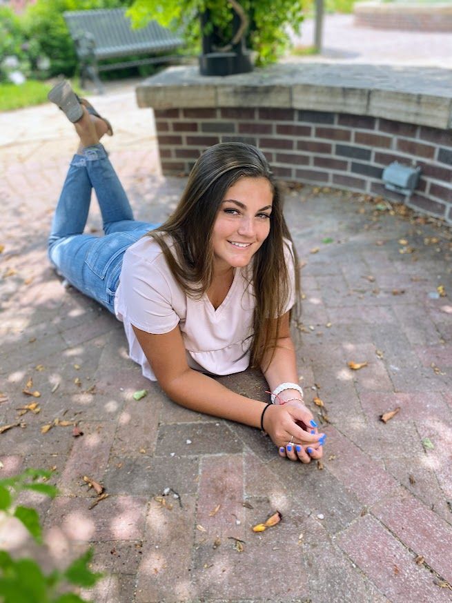 girl laying on ground smiling