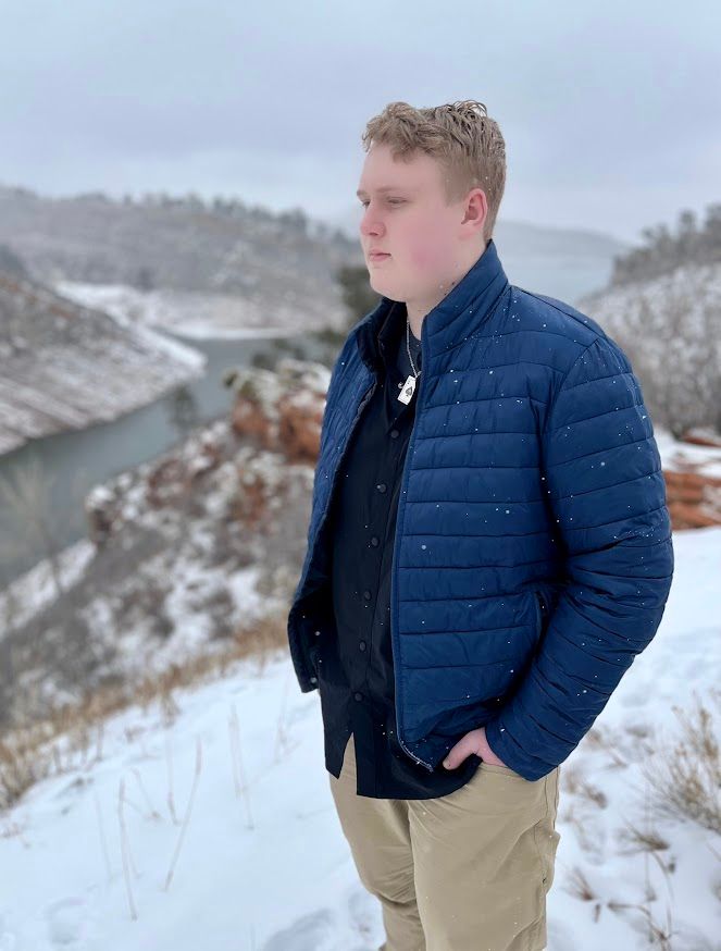 man standing looking into distance near lake