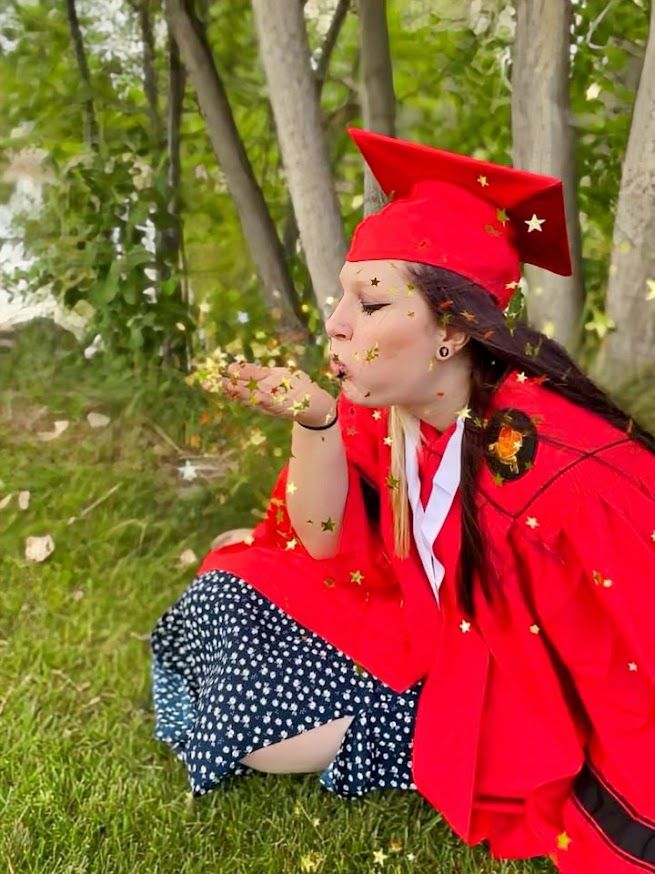 girl blowing confetti