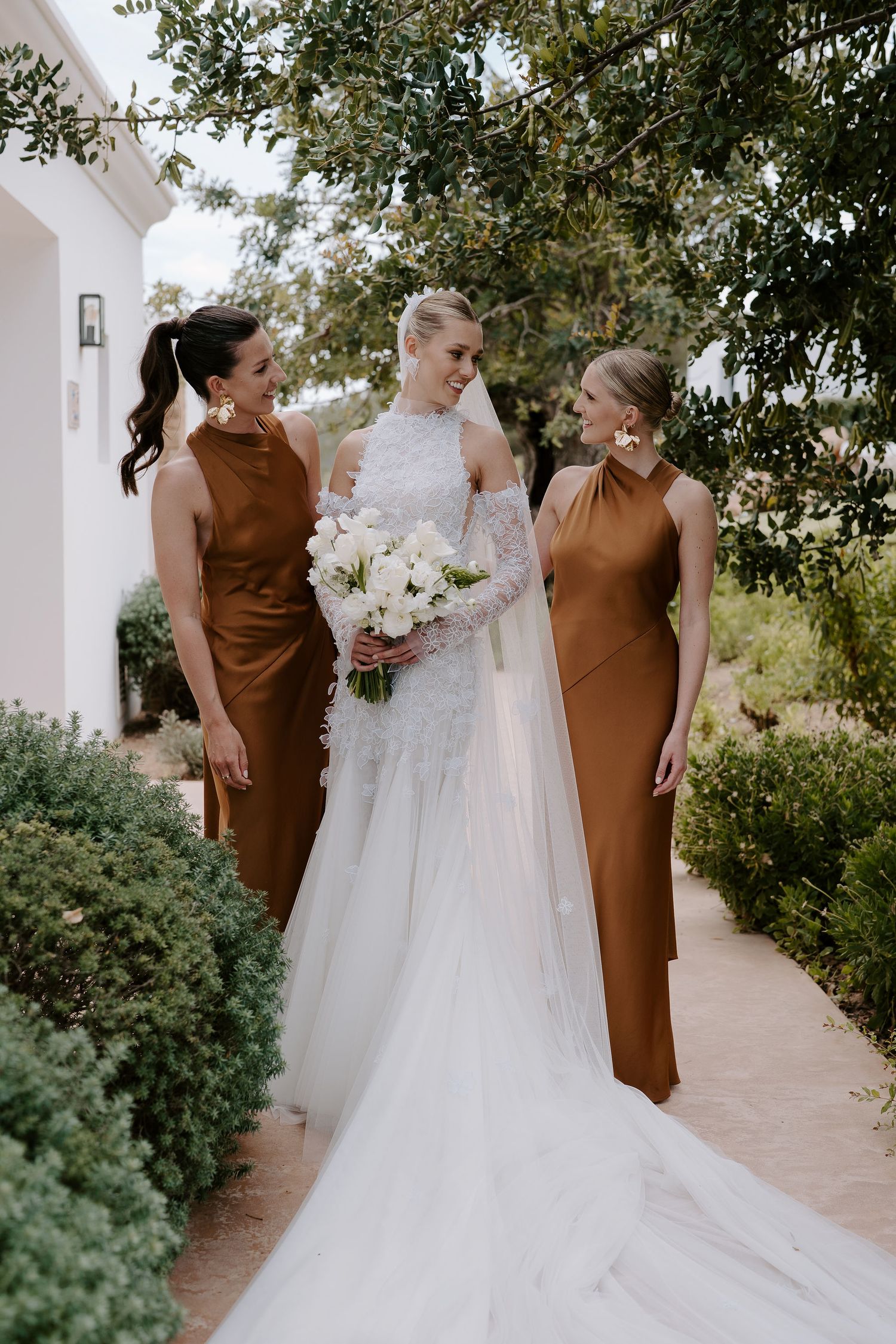 bride and bridesmaids smiling at each other at casa maca ibiza