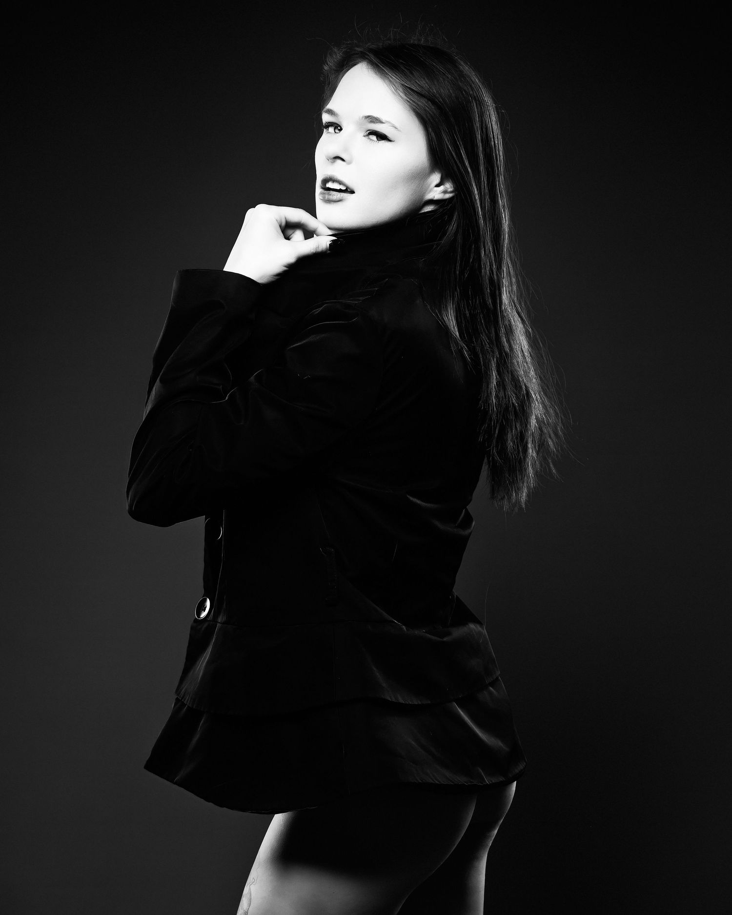 David G Holt Photography - Black and white studio portrait of a person in a velvet jacket posing dramatically against dark background.