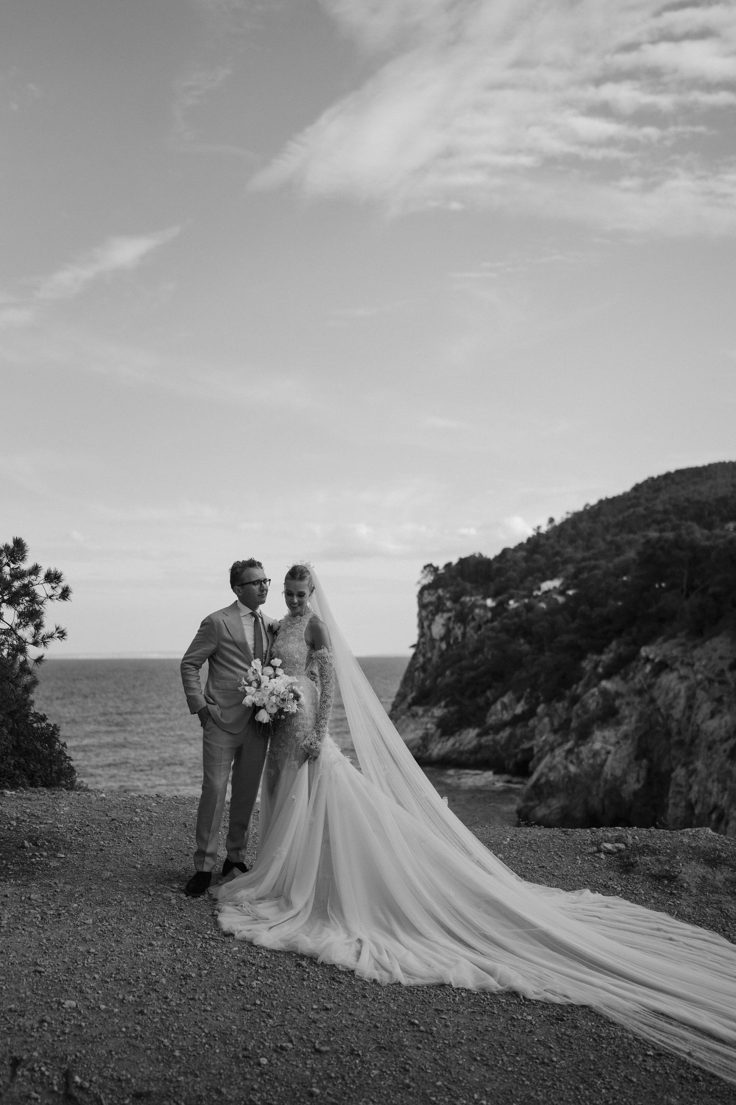 bride and groom on cliff edge at amante in ibiza