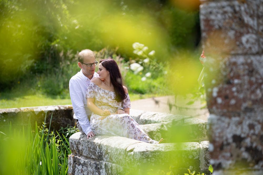 Romantic shot of couple on ancient garden wall of Kent castle