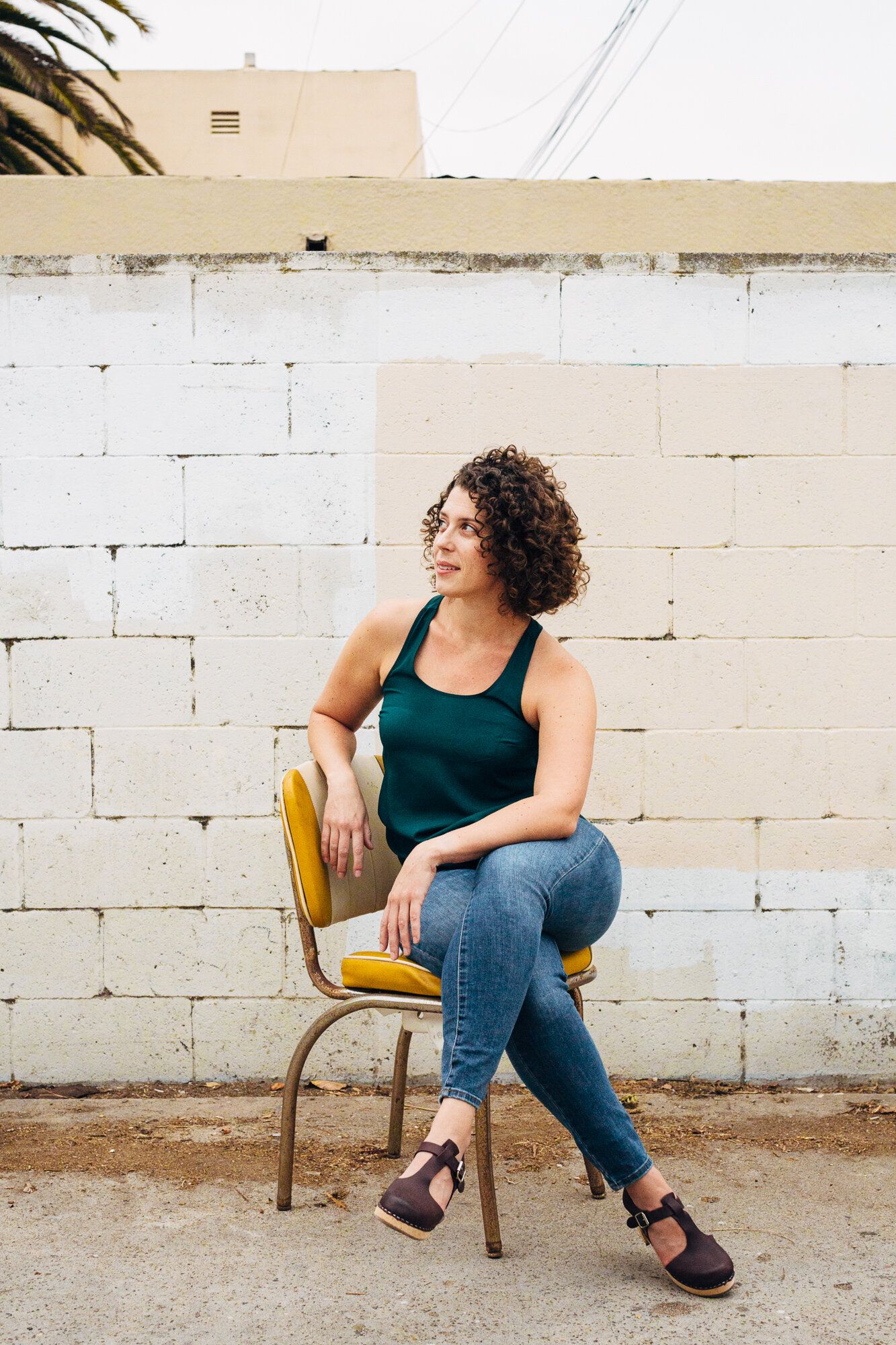 A series of lifestyle photos showing someone seated in a wooden chair against a white brick wall.