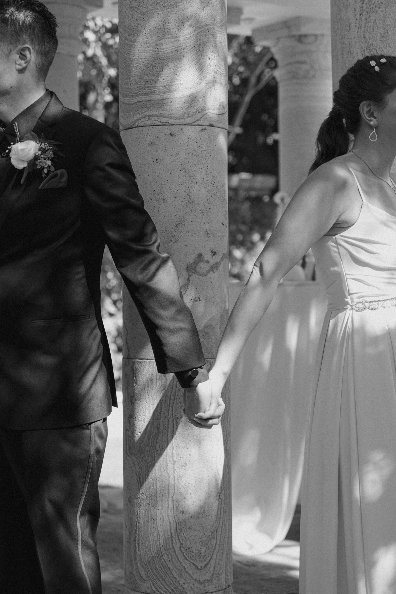 A black and white photo sequence showing a couple in formal wedding attire standing together near a pillar.