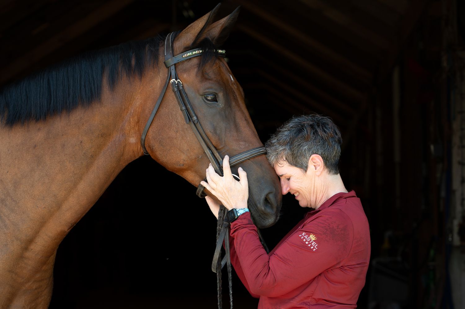Horse owner standing beside her horse sharing a peaceful connection during professional equine photography in Houston, TX