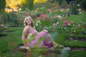 Rose Garden Julia Davis Park Boise Idaho Senior photo girl in pink dress sitting on bench in rose garden