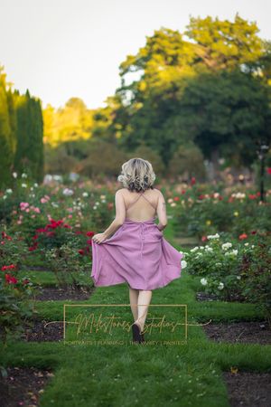 Rose Garden Julia Davis Park Boise Idaho Senior photo girl running through roses wearing pink dress