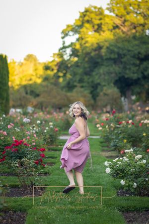 Rose Garden Julia Davis Park Boise Idaho Senior photo girl running through roses looking back