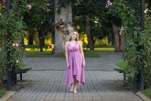 Rose Garden Julia Davis Park Boise Idaho Senior photo girl in pink dress standing at entrance of rose garden park