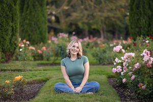 Rose Garden Julia Davis Park Boise Idaho Senior photo girl wearing green t-shirt and jeans sitting in rose garden
