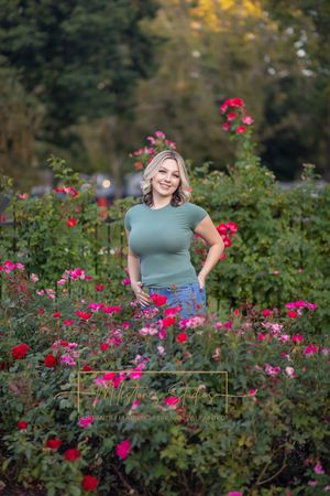 Rose Garden Julia Davis Park Boise Idaho Senior photo girl wearing green t-shirt and jeans surrounded by roses