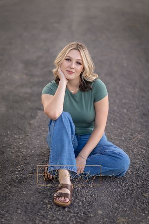 Rose Garden Julia Davis Park Boise Idaho Senior photo girl wearing green t-shirt and jeans sitting in path