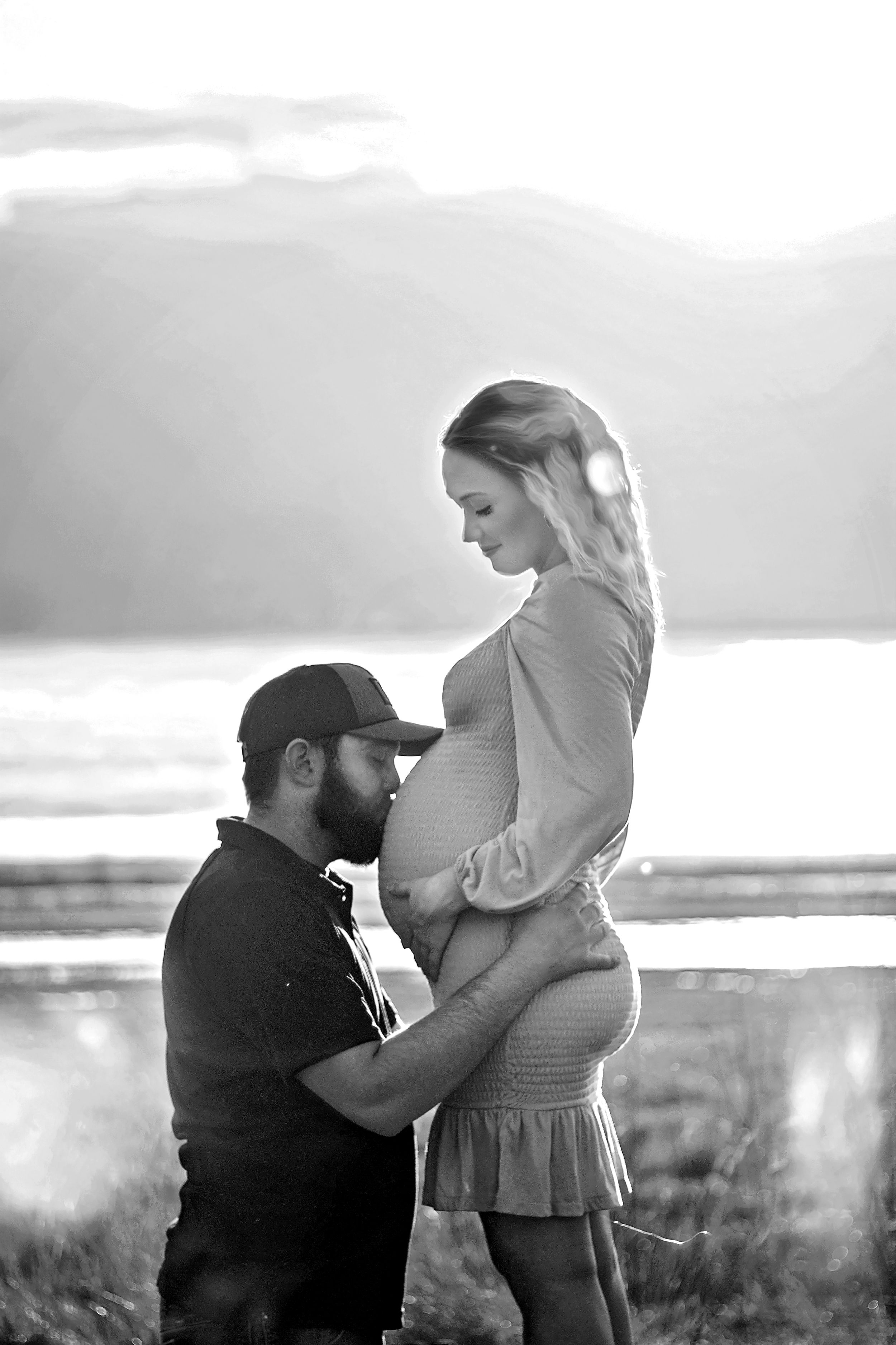 A black and white photo sequence shows a couple sharing an intimate moment in a scenic outdoor setting in Williston, North Dakota.