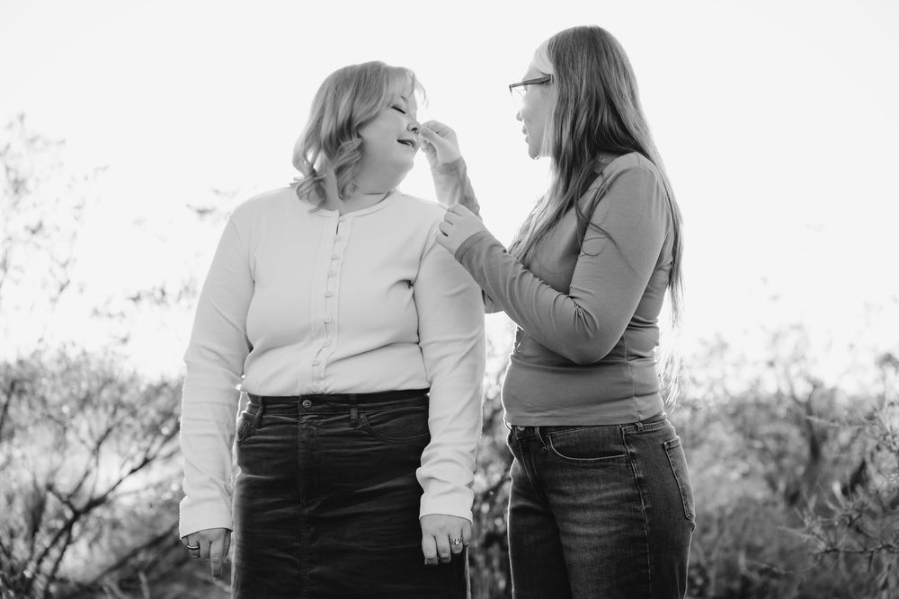 A black and white photo collage showing candid moments between two people in casual attire outdoors.