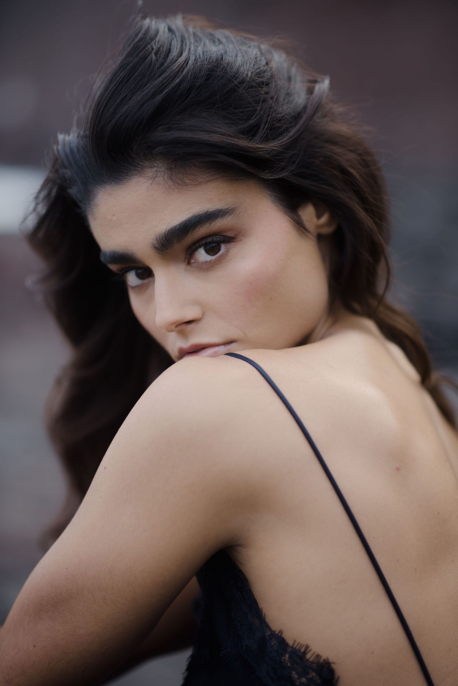 Artistic black and white portrait series showing close-up profile angles against dark background.