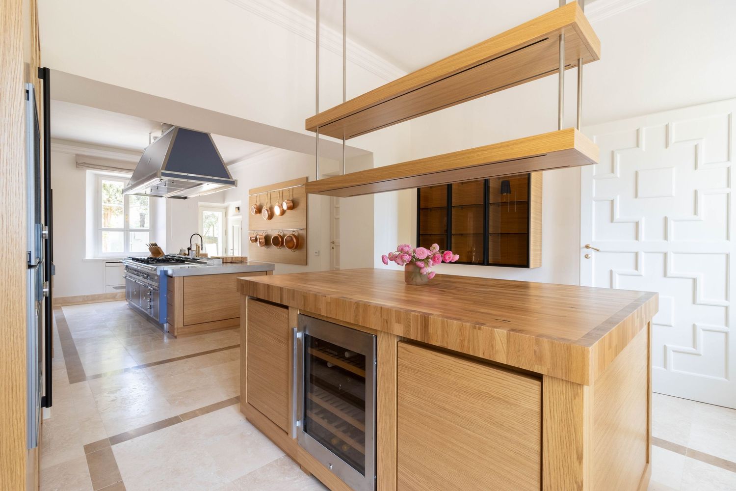 Tuscany Italy villa property photographer. Modern kitchen interior with light wood cabinets.