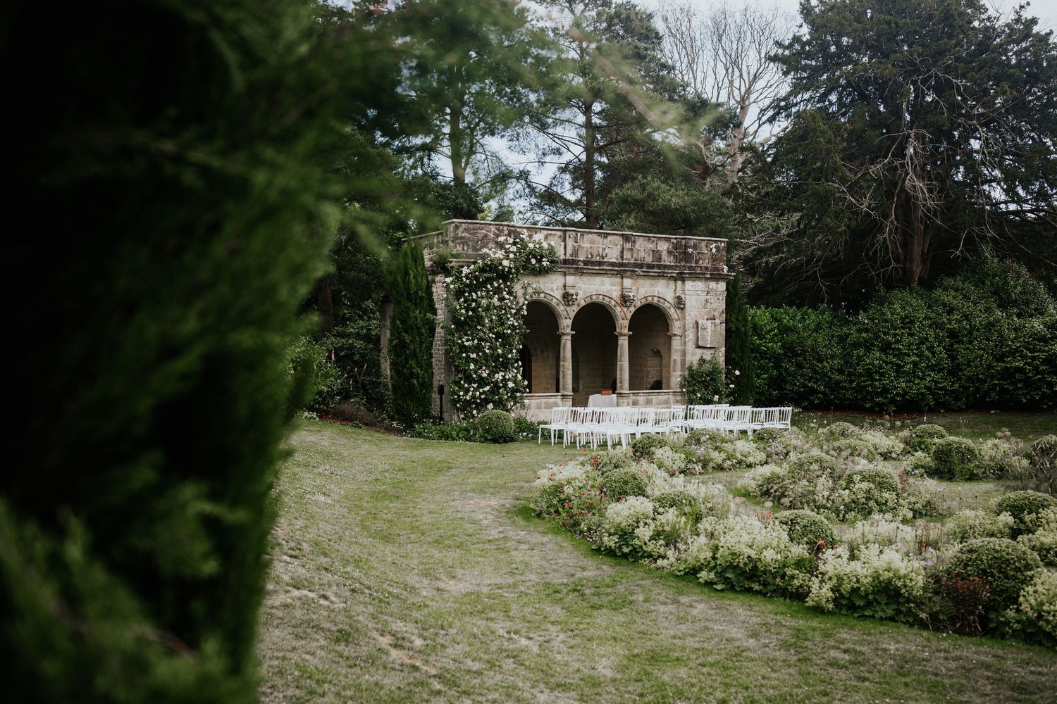 Outdoor wedding ceremony setup at the Loggia in the Sunk Garden at Nymans Gardens