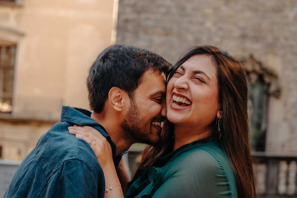 Couple playing around the old little streets of Barcelona.