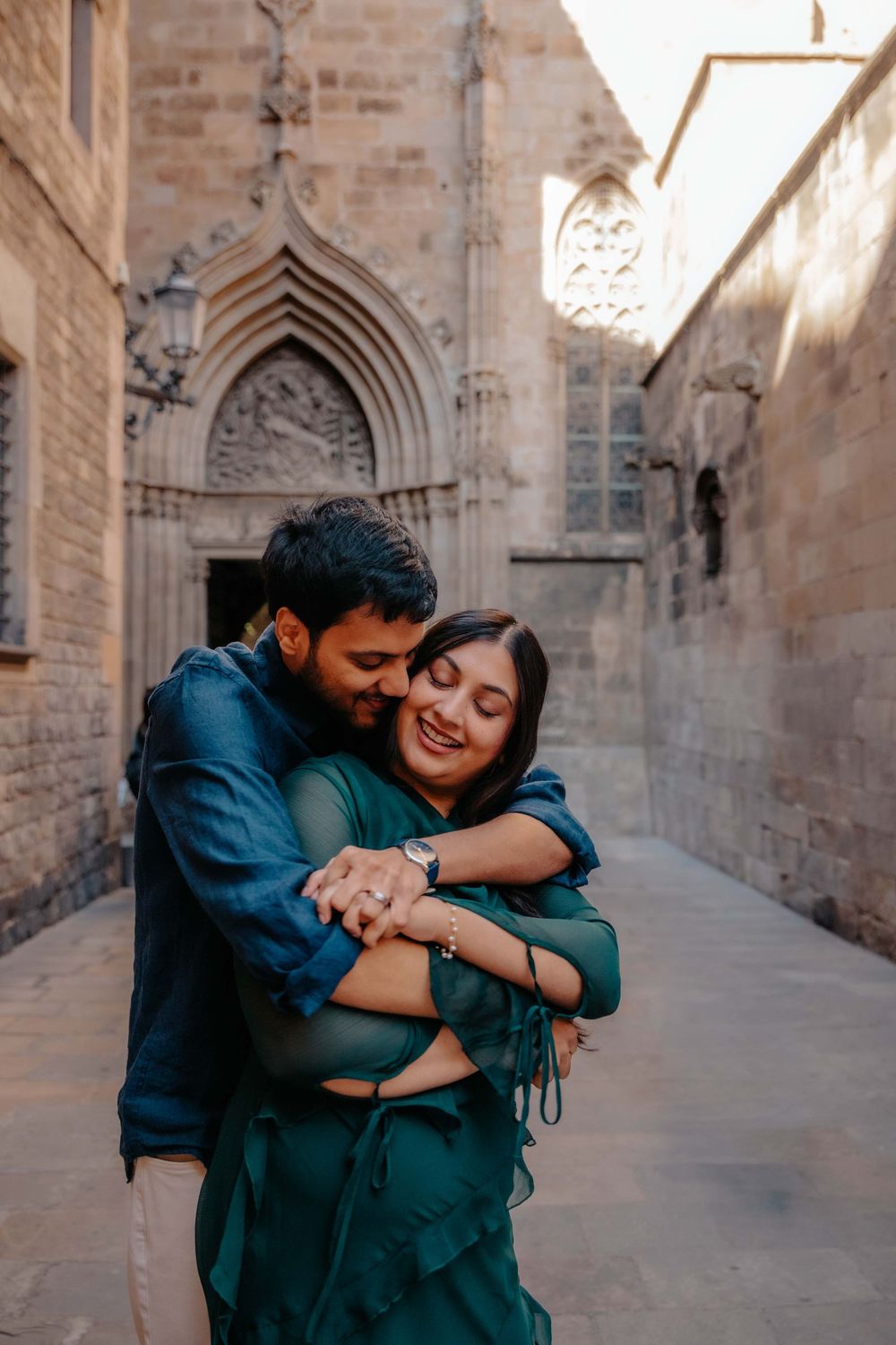 Sara and Owais laughing together in the empty streets of Barcelona Old City.