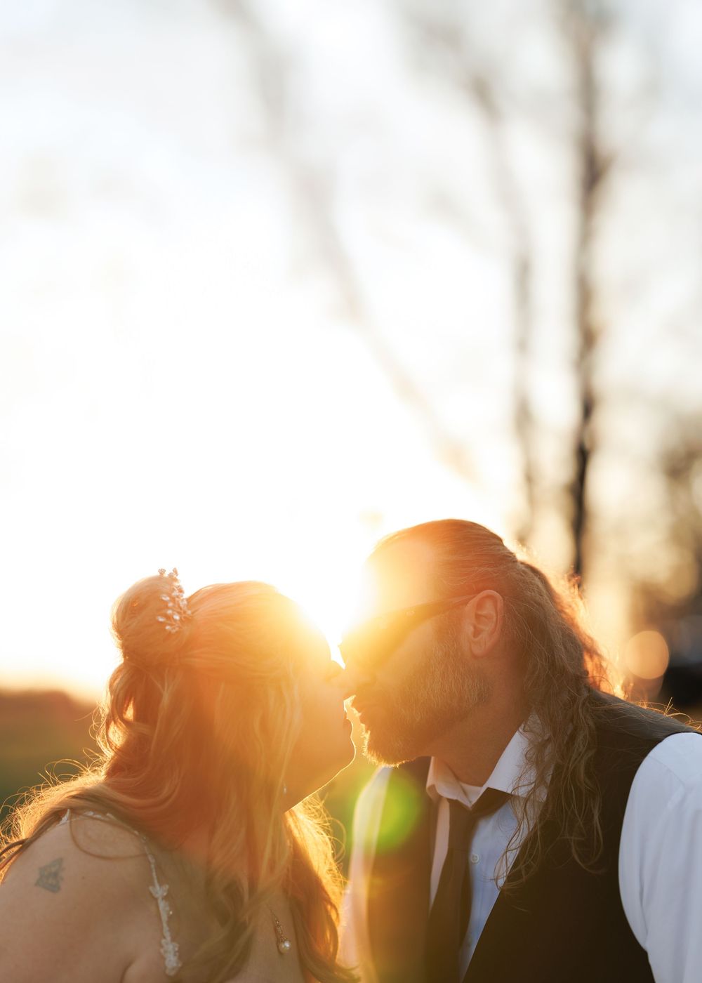 Group of people silhouetted against golden sunset light.