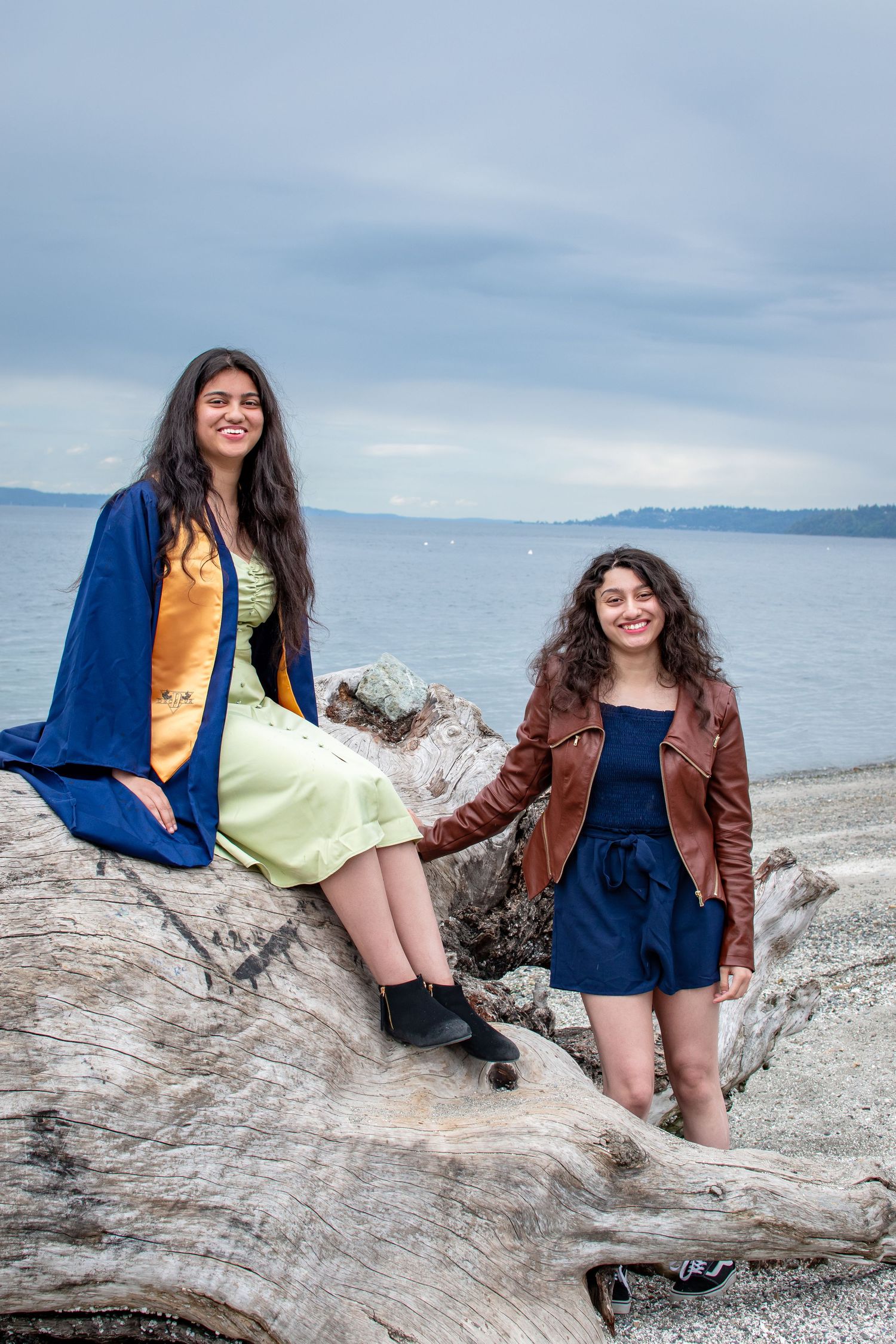Graduation photo of a senior girl and her older sister at Redondo Beach in Federal Way, located south of Seattle, Washington.