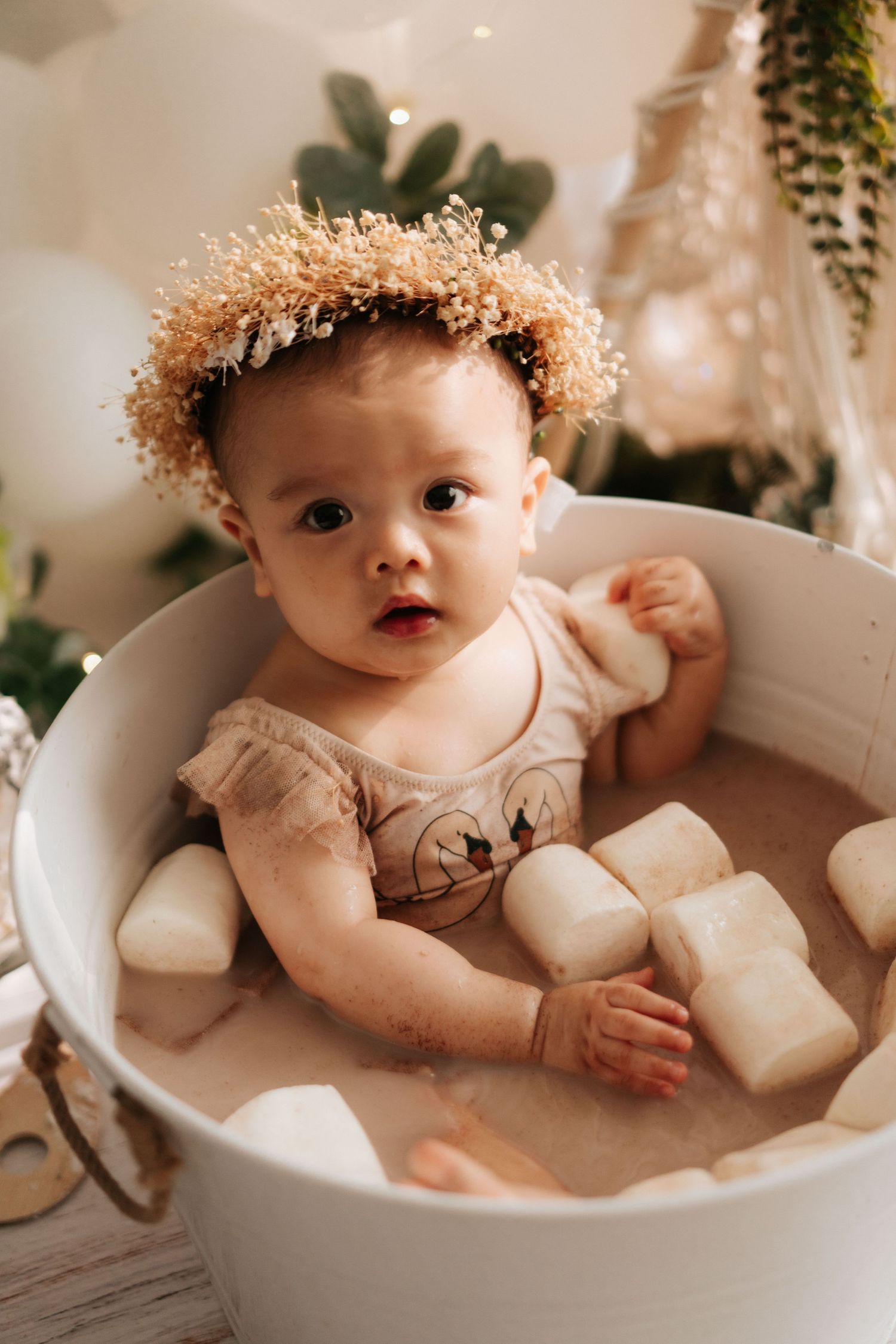 Series of cake smash photos with white dress, teddy bears, balloons and orange backdrop for baby milestone celebration.