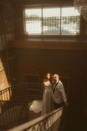 Romantic indoor scene with warm lighting and wrought iron railings.