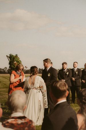 Wedding party and guests mingling during an outdoor ceremony.