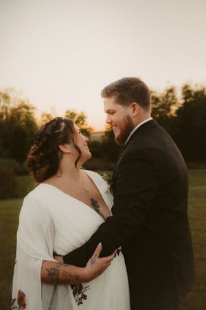 A romantic sunset wedding portrait showing tender moments between newlyweds.