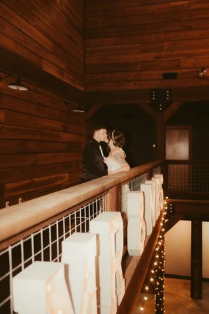 A romantic sequence of wedding photos showing a couple dancing together under warm lighting and wooden beams.