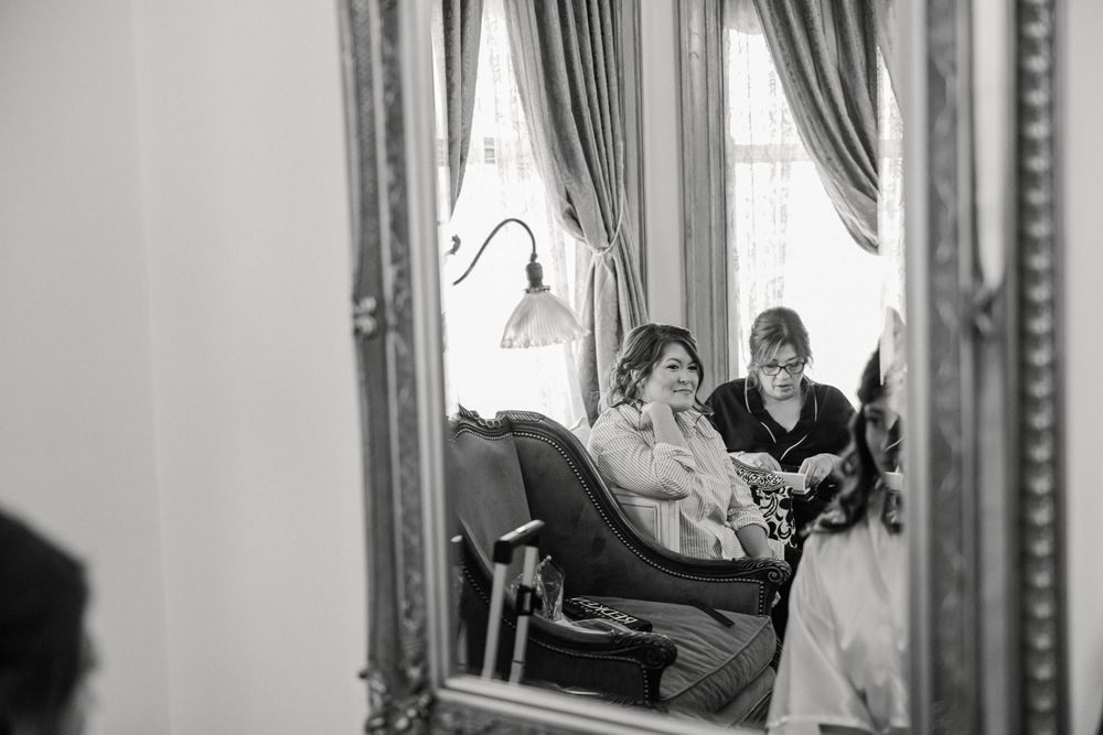 Couple sharing a romantic first look moment before their wedding ceremony in an elegant indoor setting.