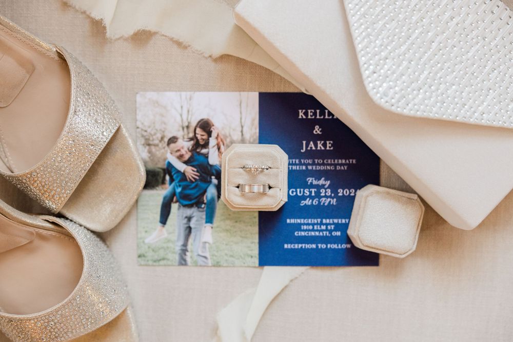 Elegant wedding invitation suite with beige envelopes and blue cards arranged artistically on white background.