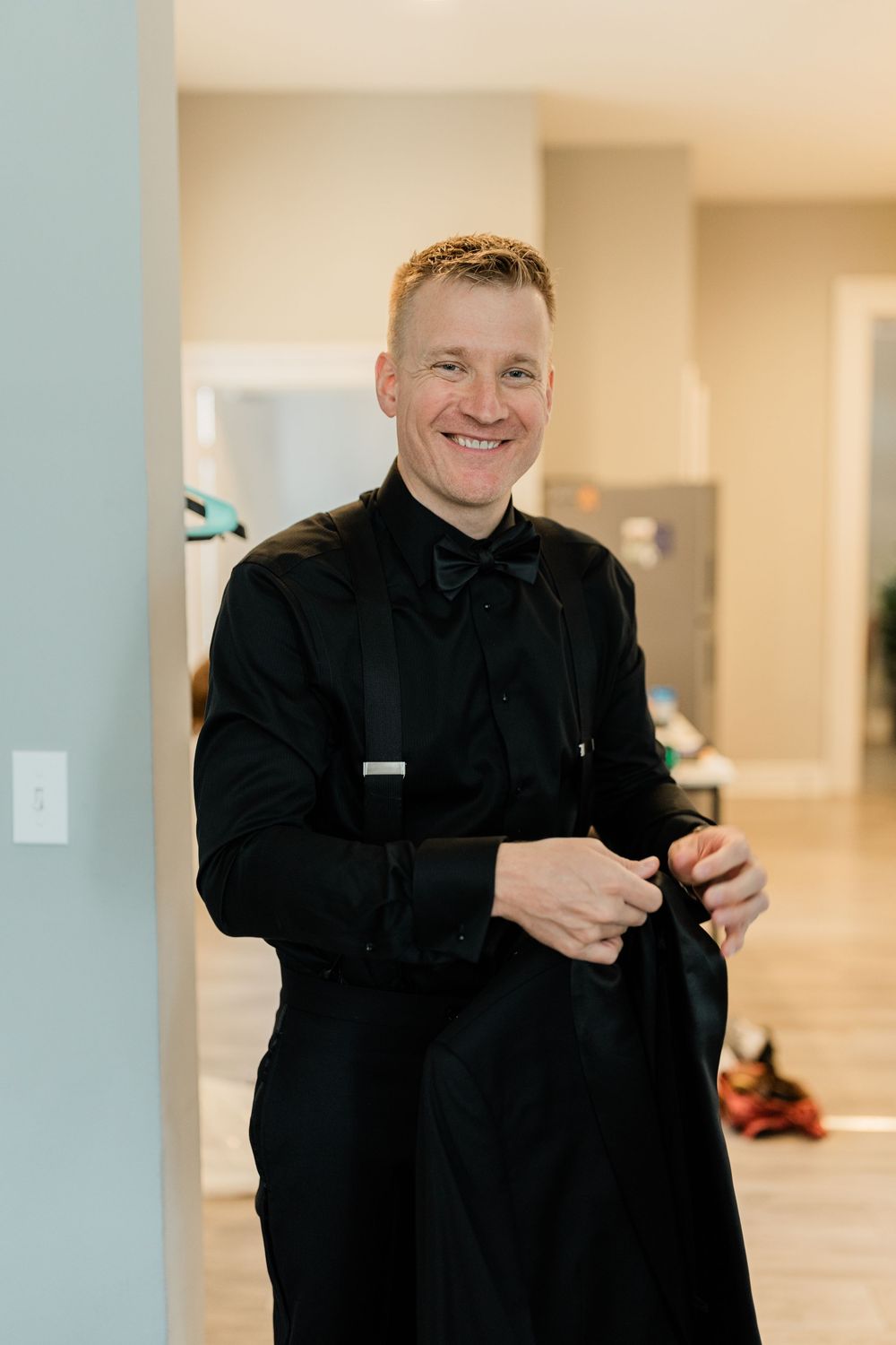 Sequence of someone in black attire smiling and getting ready.