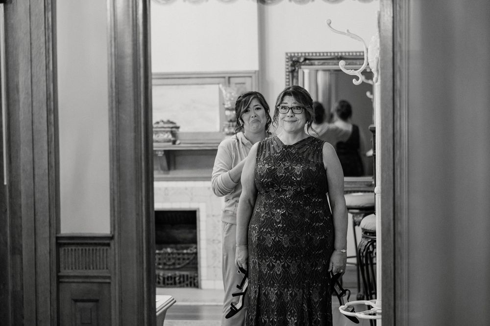 Black and white photo showing people dancing and celebrating in an elegant room.