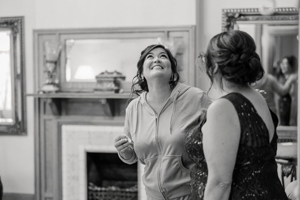 A series of candid black and white photos capturing joyful moments at an indoor celebration.