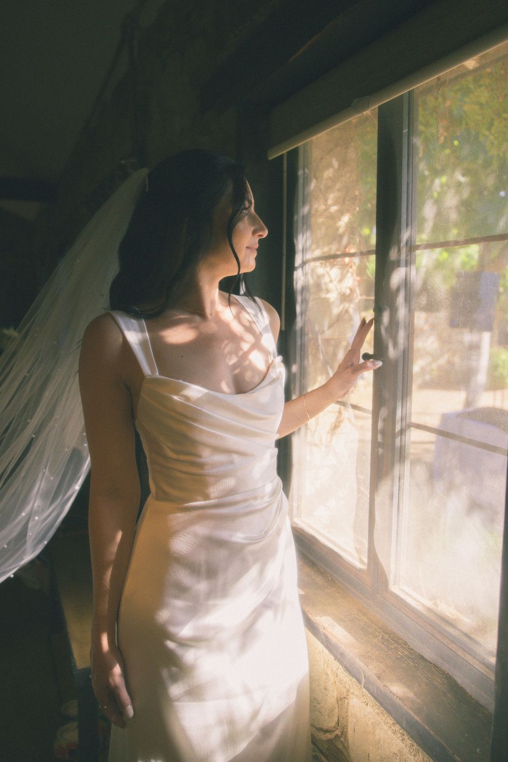 A sequence of four dreamy photos shows a person in white fabric standing by a sunlit window.
