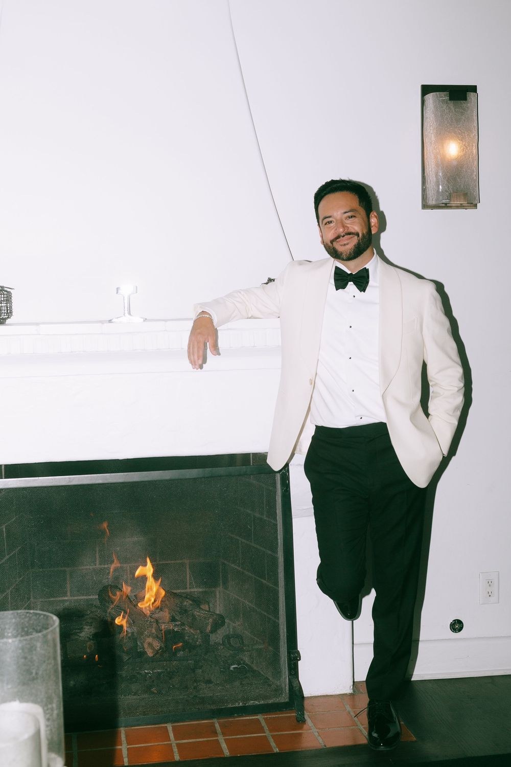 A series of photos showing a person in formal attire posing near a fireplace with flames visible in the final frame.