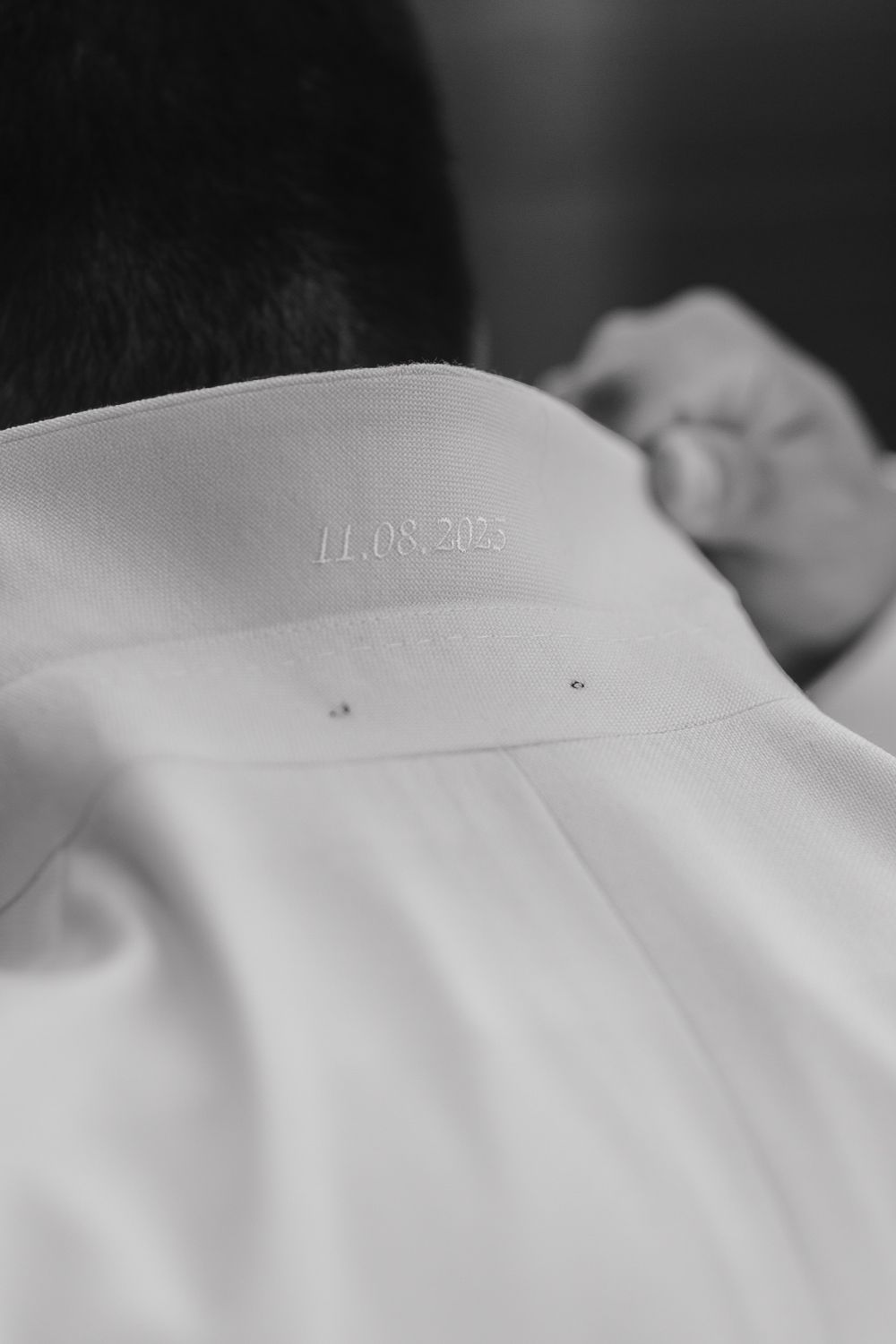 A black and white close-up of a white garment with a date stamp showing 11.08.2023.