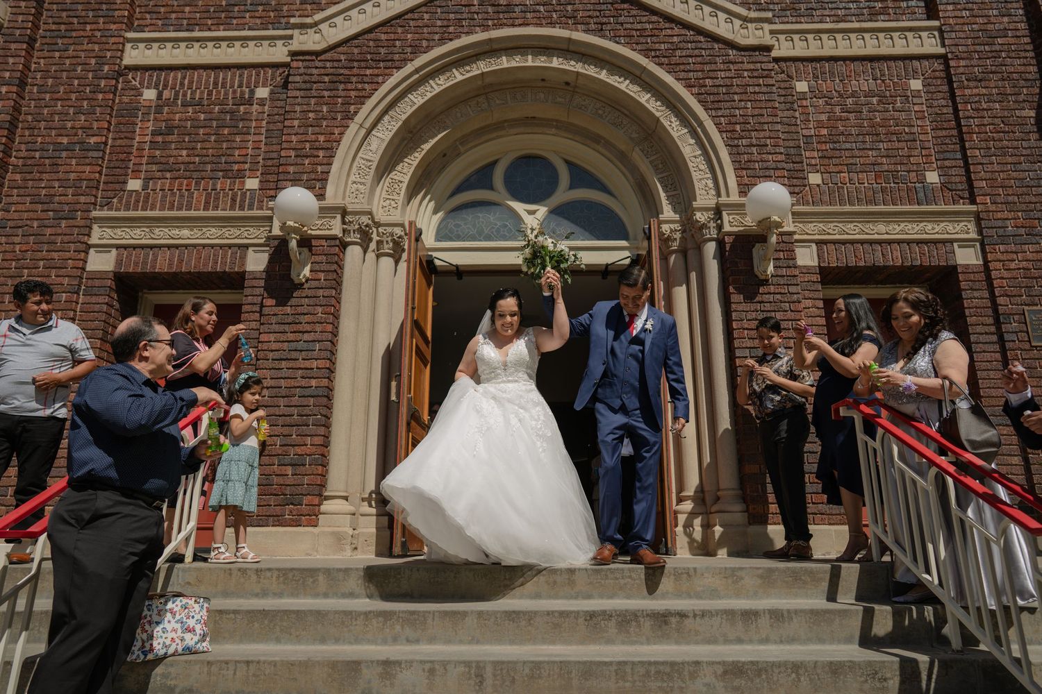 A series of black and white photos showing a flowing white wedding dress against a rustic barn backdrop.