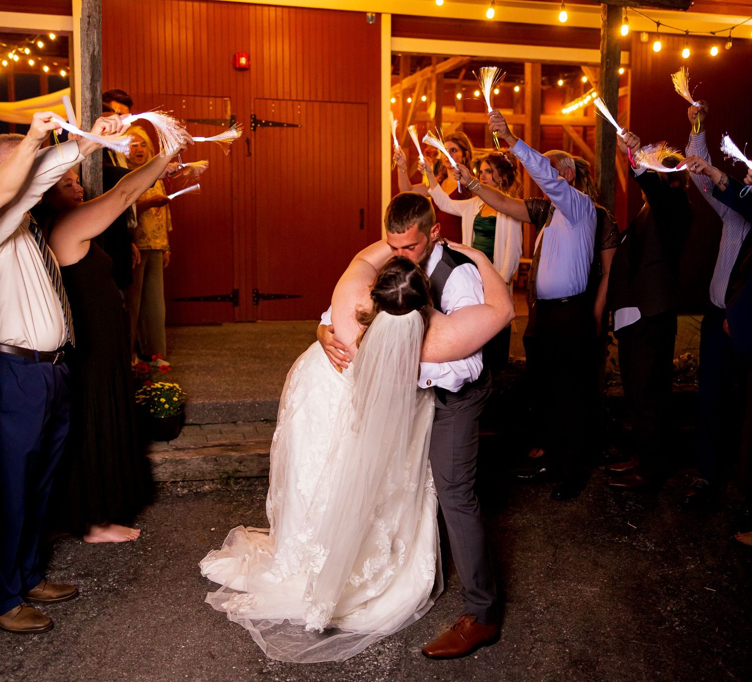 frederick maryland wedding photographer Bride and groom exit their reception through a tunnel of cheering wedding guests.