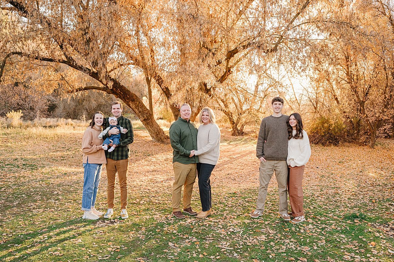 Casual outdoor gathering captured against a backdrop of fall foliage and natural scenery.