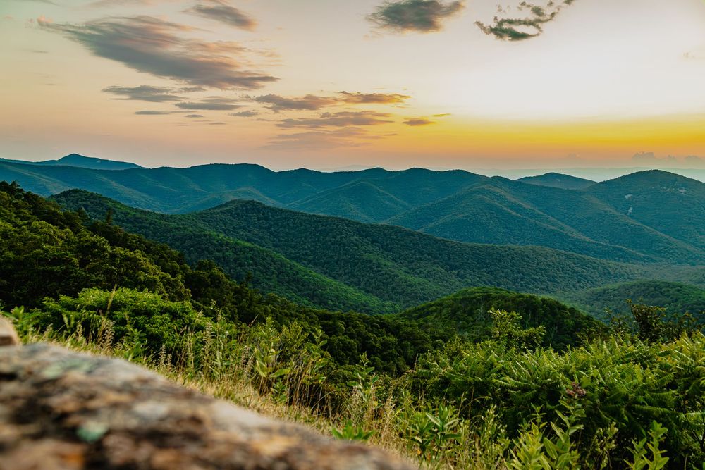 Rolling mountains of the Shenandoah range stretch into the distance under a golden sunset sky in Virginia