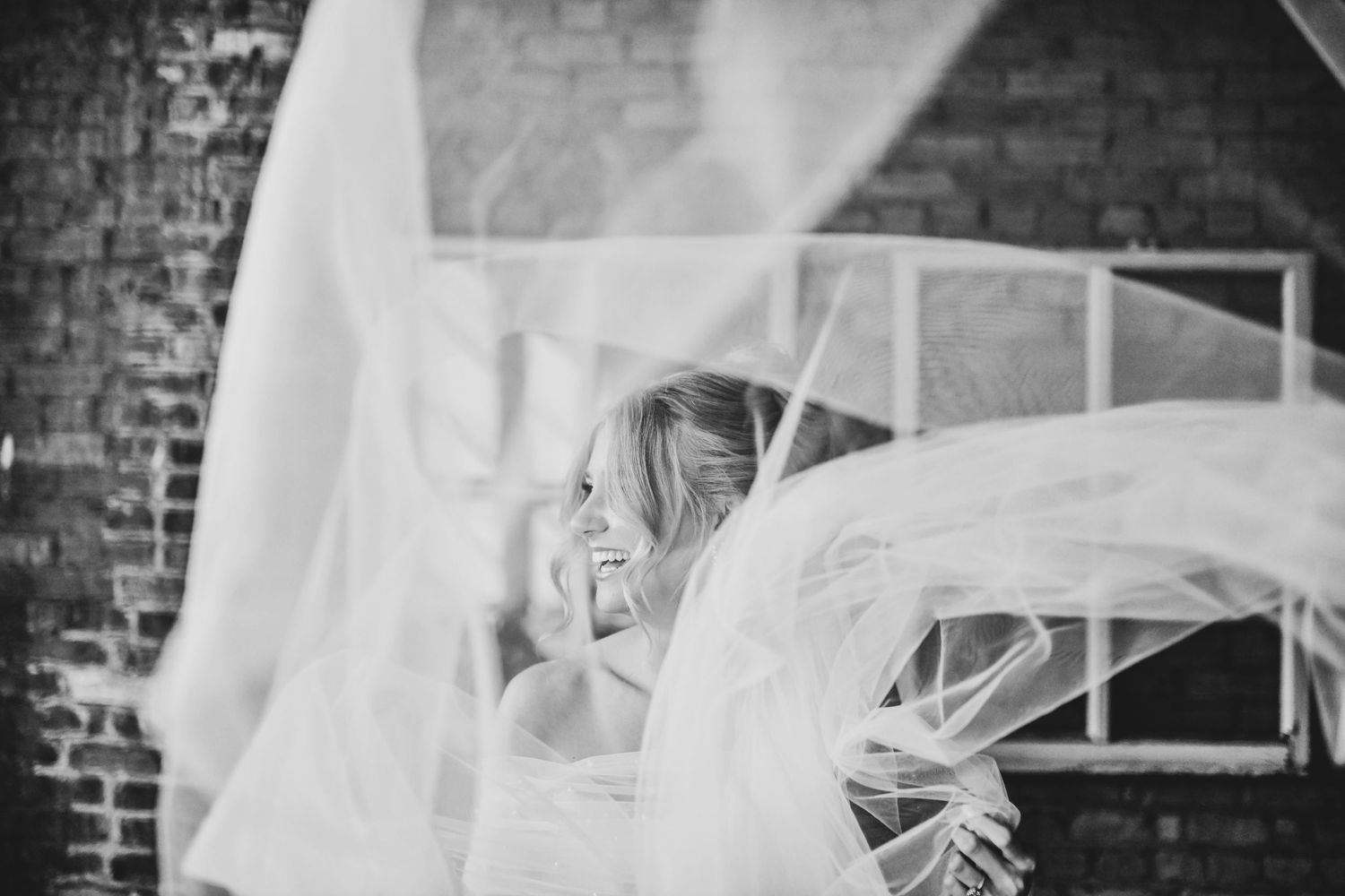 Bride standing confidently in elegant wedding dress