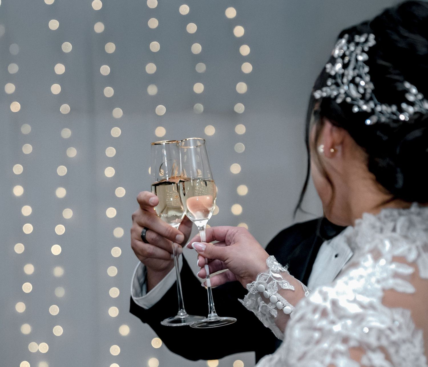 Bride and groom raising a glass or Champagne at a Texas wedding ceremony, captured by Raggio Media Photography.