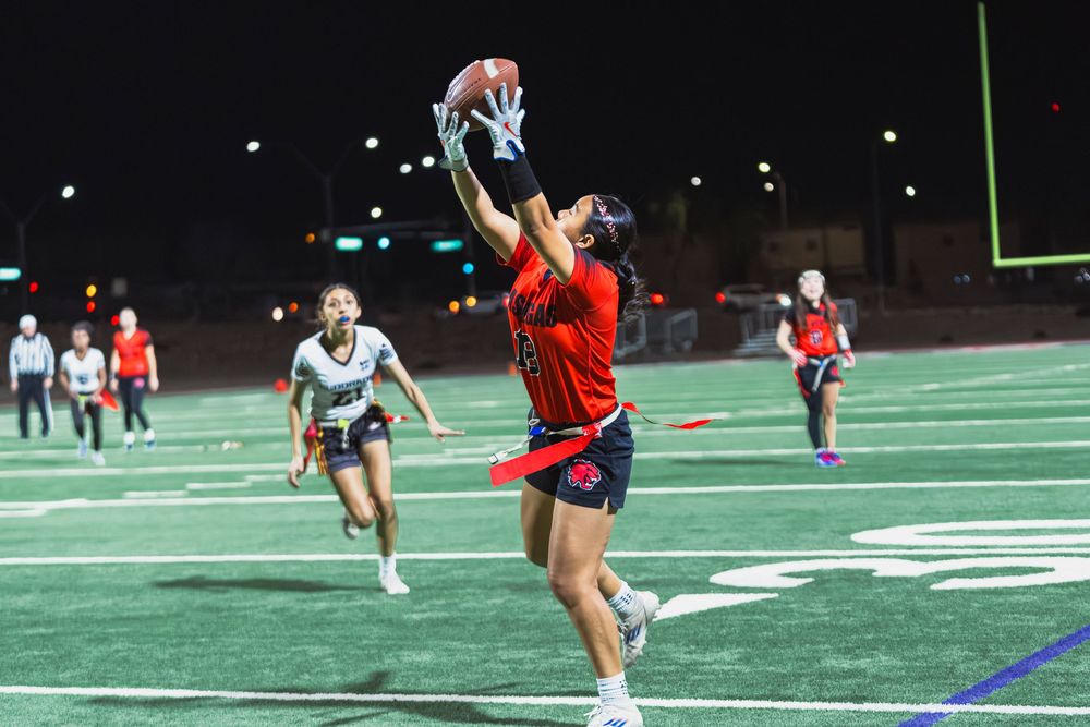 Girls flag football player catching the football